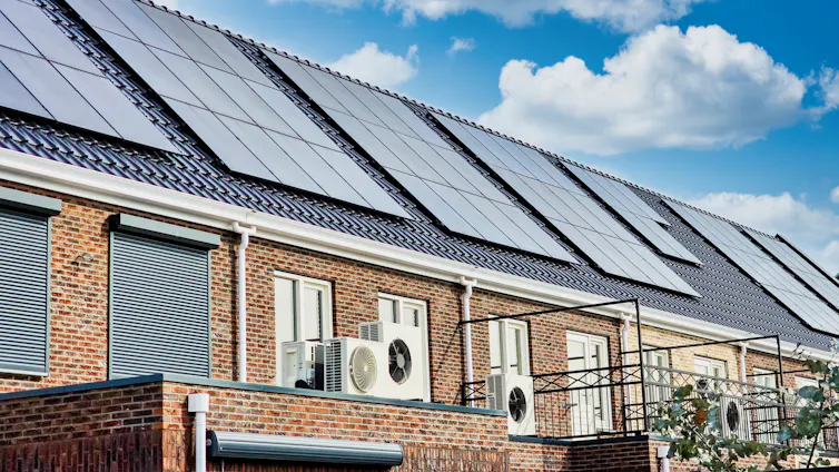 new houses with solar panels on roof, blue sky