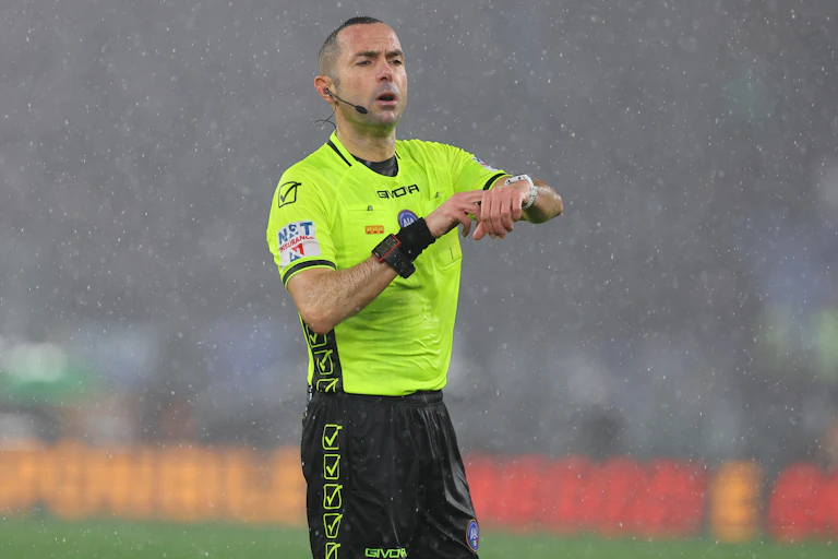Italian referee Marco Guida signals that he is taking account of time wasting during a Serie A football match.