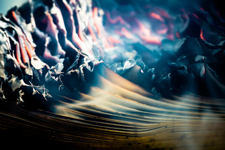 A stack of papers on fire.