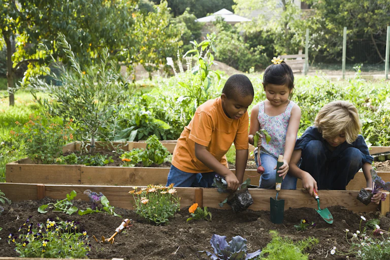 Three children gardening.