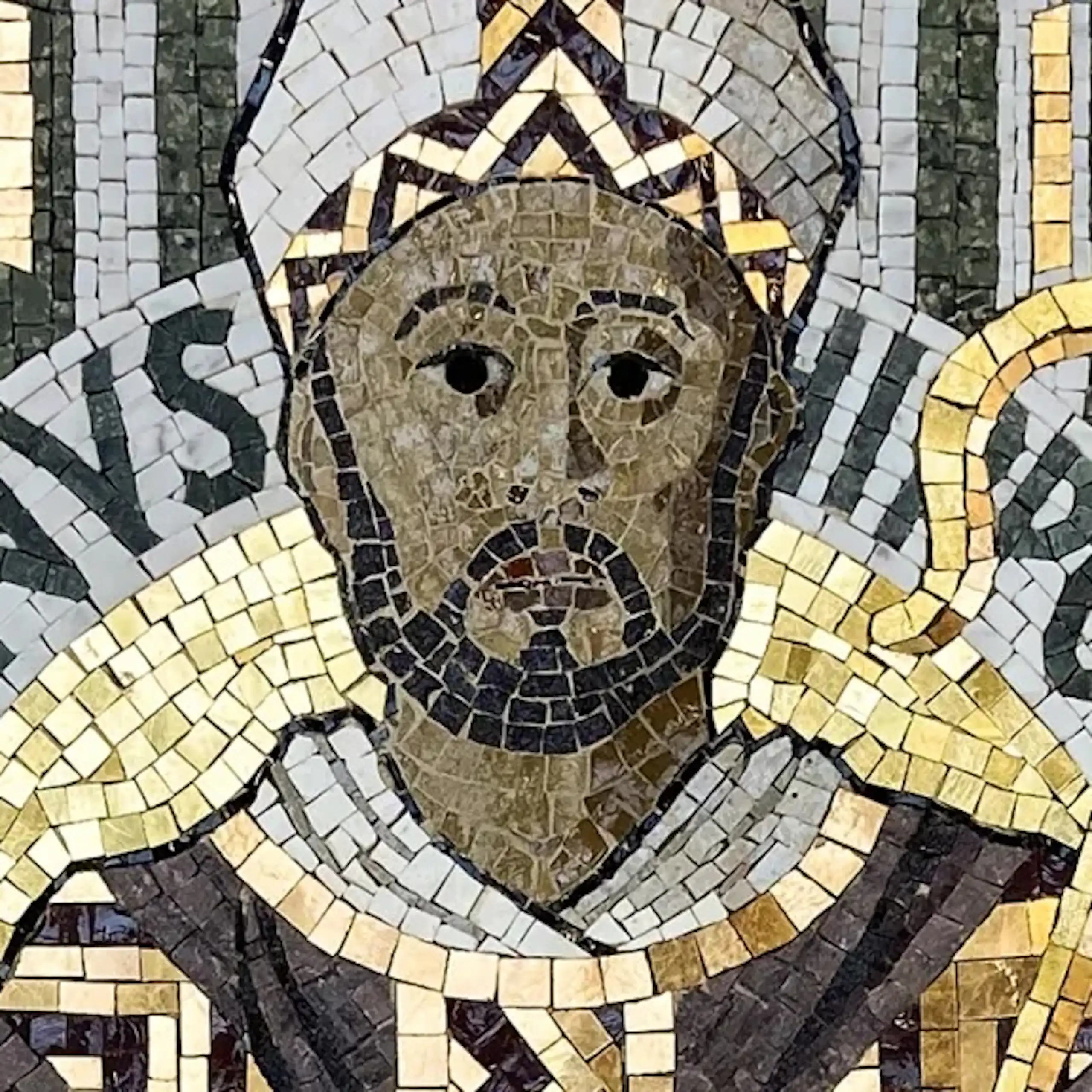 A mosaic artwork of a dark-skinned man in a bishop's headgear holding a staff.