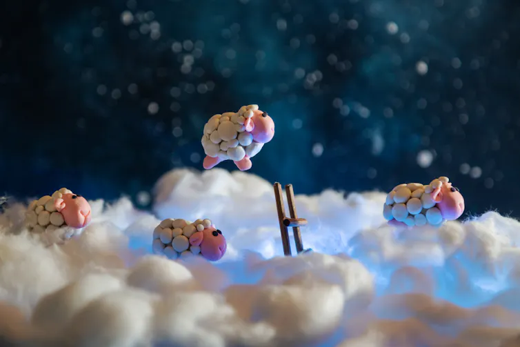 Plasticine sheep jumping among clouds
