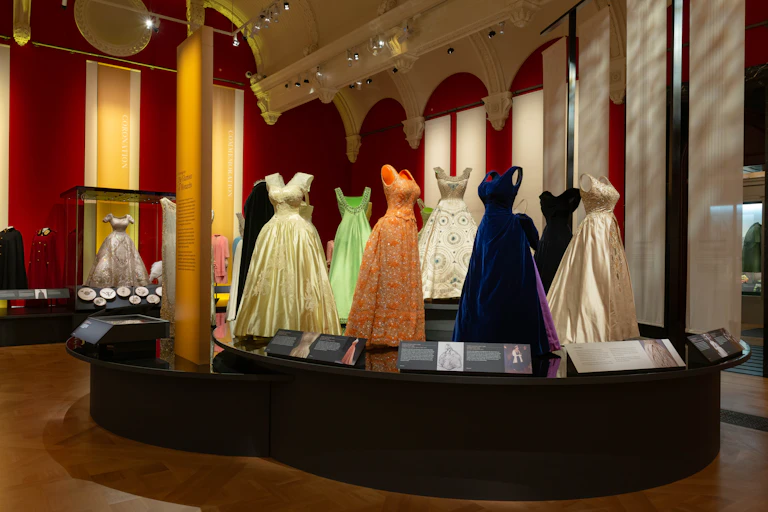 A selection of elegant evening dresses in a fashion exhibition.