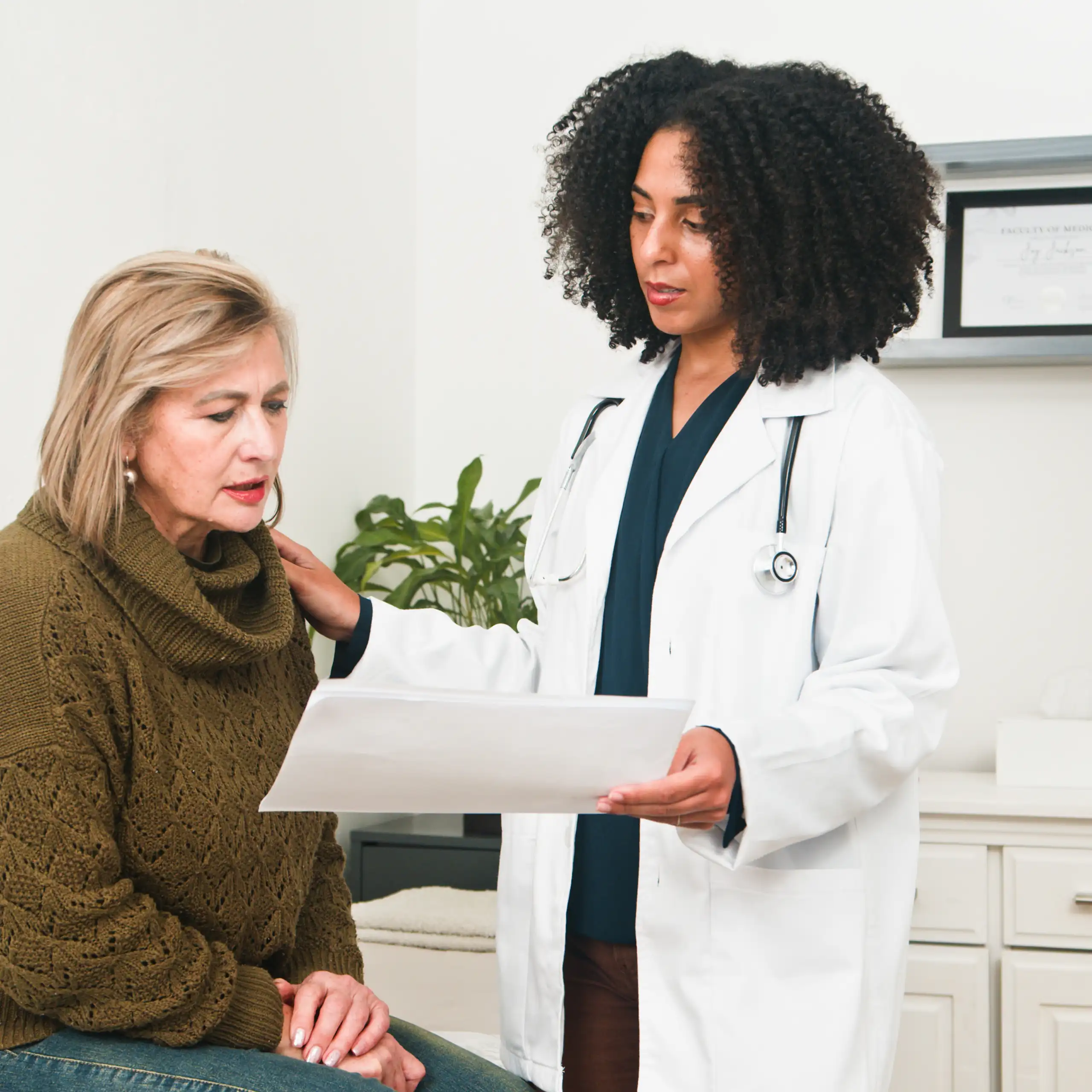 Une médecin montre des résultats à sa patiente.