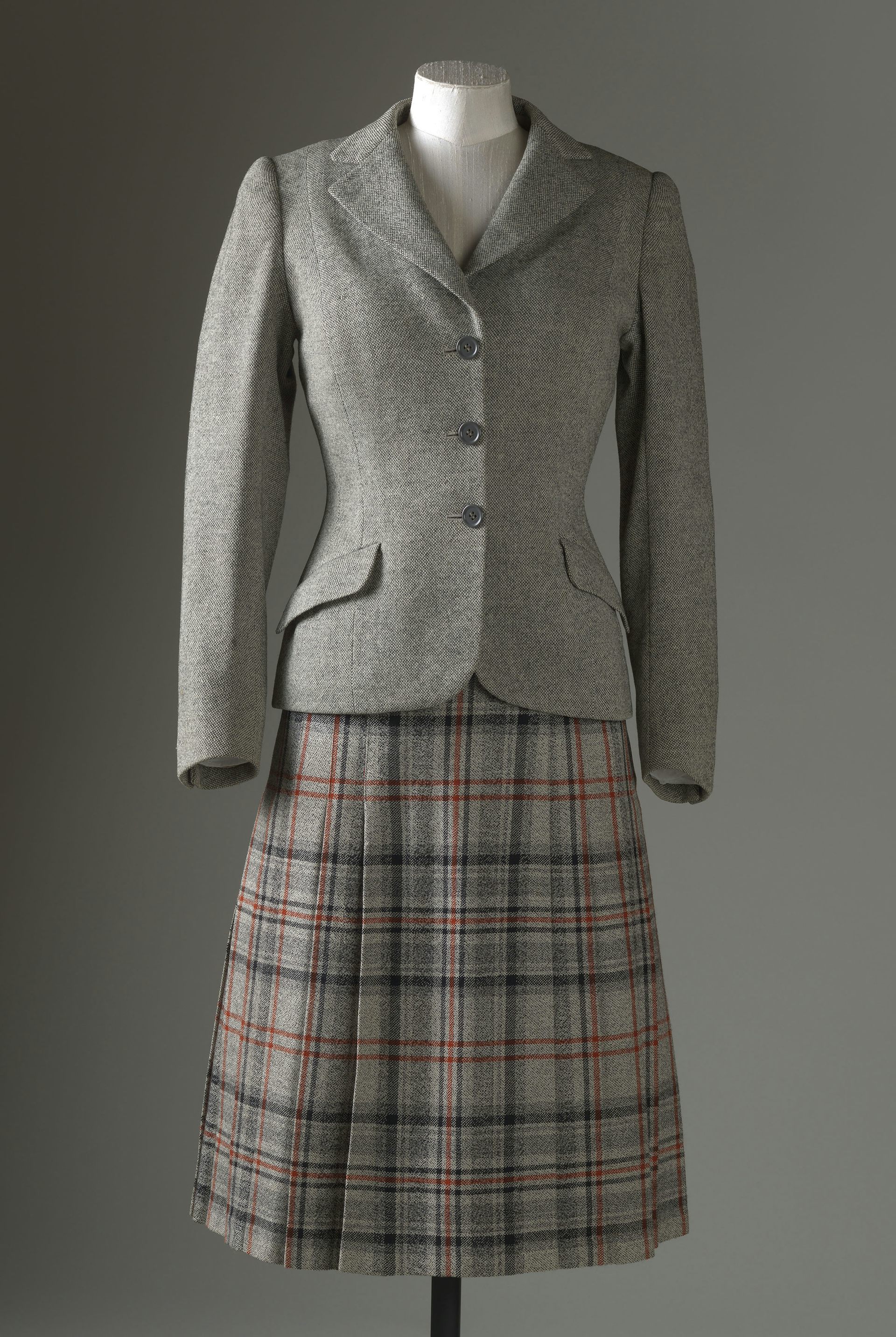 A women's Harris Tweed Jacket and kilt on a mannequin.