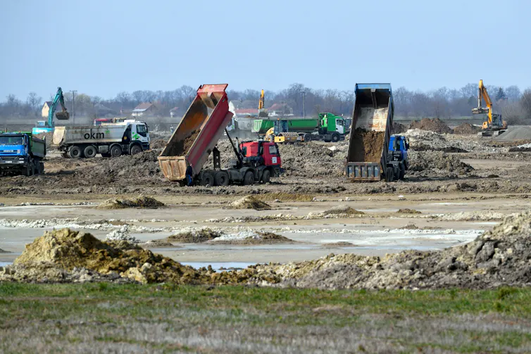 Machines carry out soil preparation works on the site of a future battery-making plant in Hungary.