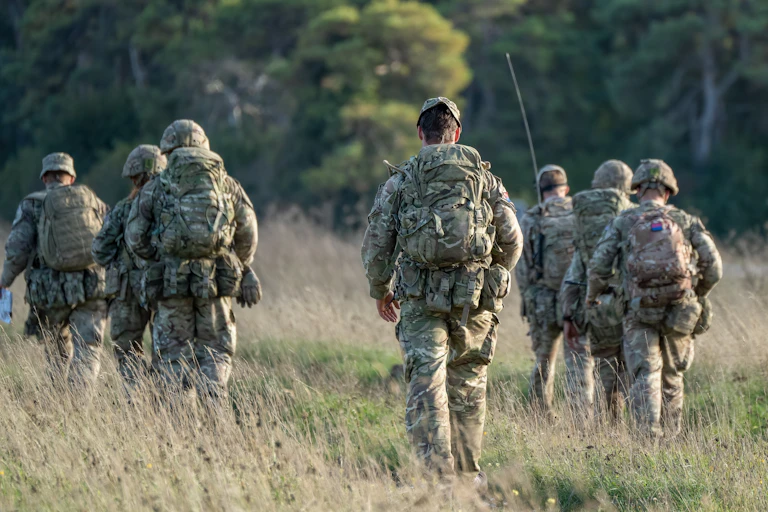 View from behind of British soldiers walking in a field