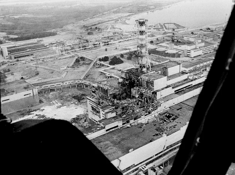 An aerial view of a large building damaged by an explosion.