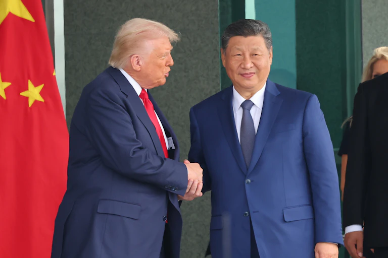 US president DOnald Trump shakes hands with Chinese president Xi Jinping.