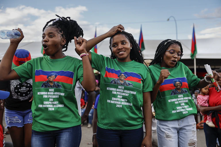 Women in green T-shirts celebrate