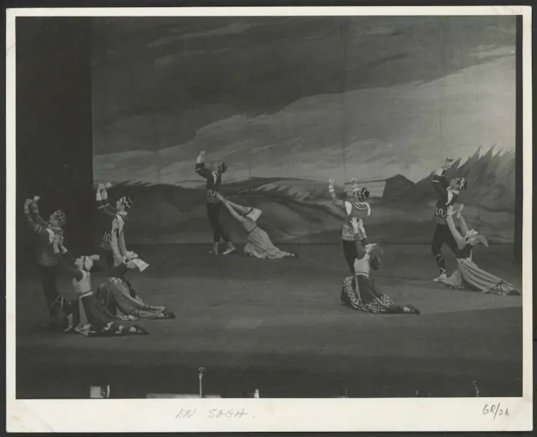 Black and white photo: pairs of dancers on stage.