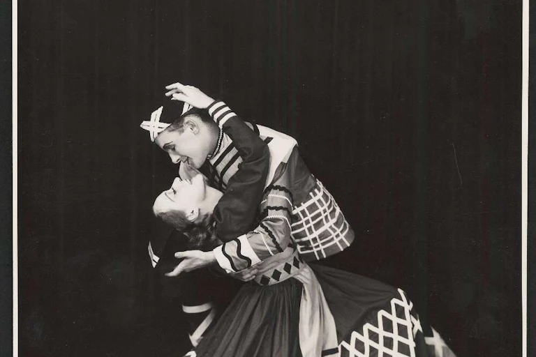 Two dancers embrace.