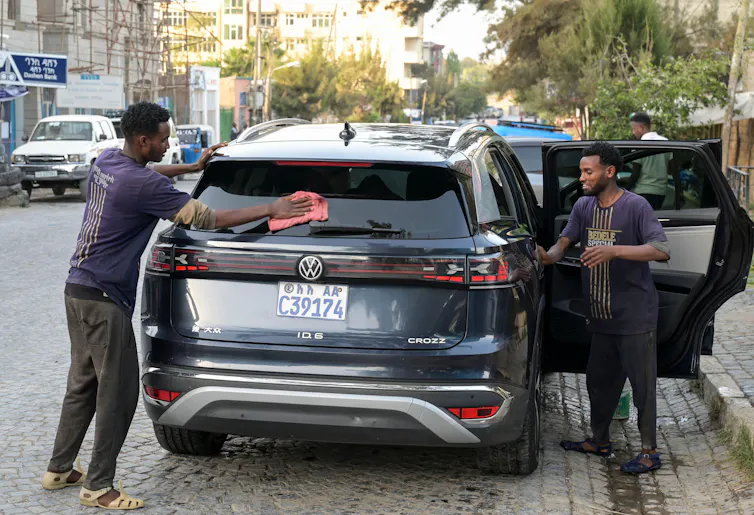 Two men wash an EV in Tigray, Ethiopia