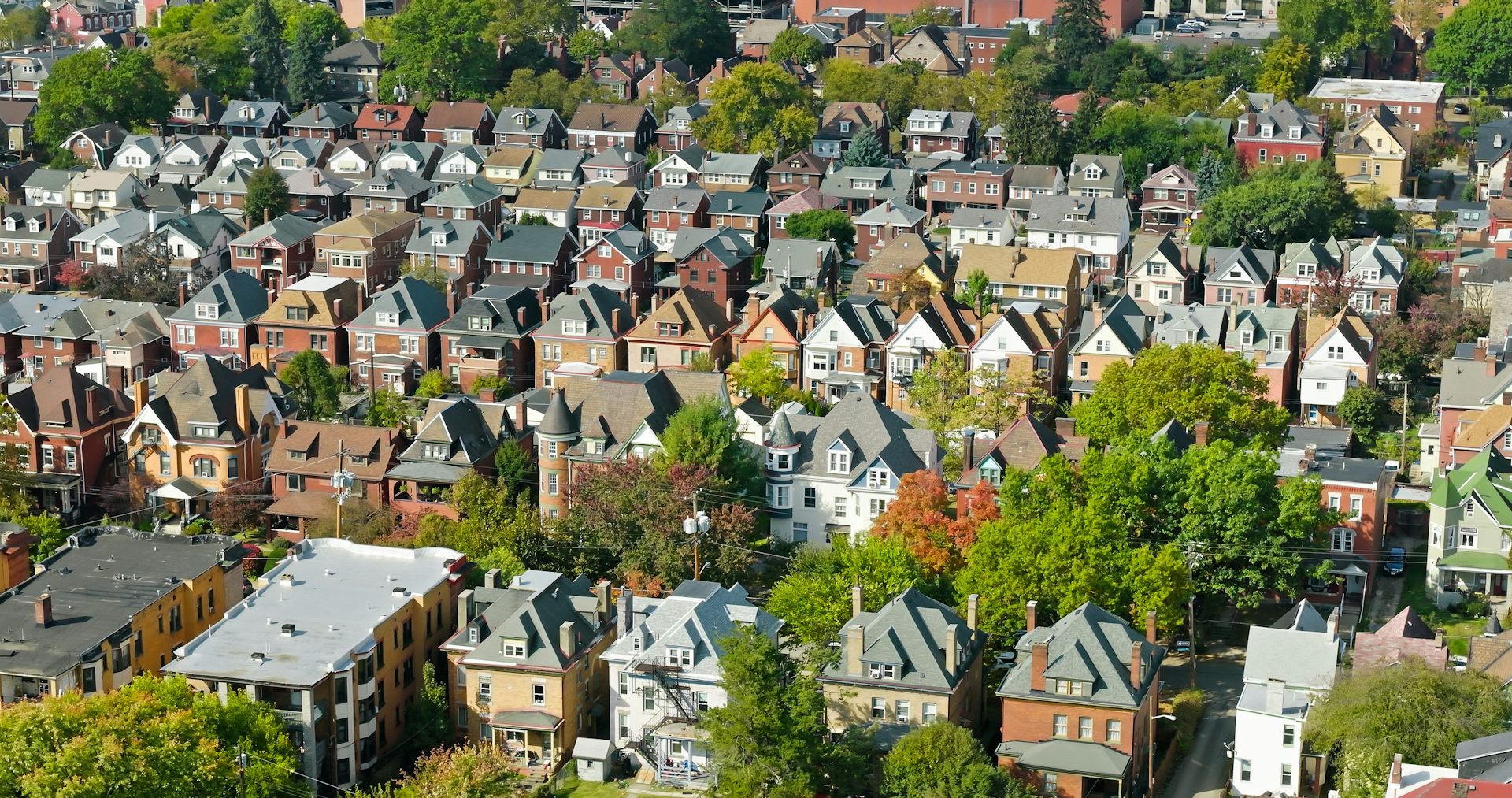Aerial view of several rows of houses in a large neighborhood.
