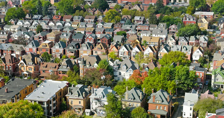 Aerial view of several rows of houses in a large neighborhood.