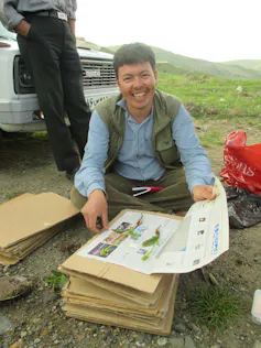 researcher sat with documents looking for orchids