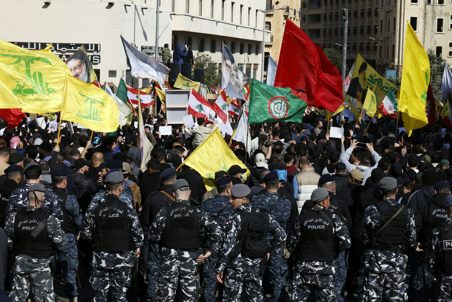 Hezbollah supporters carry their party's flags during a protest in Beirut.
