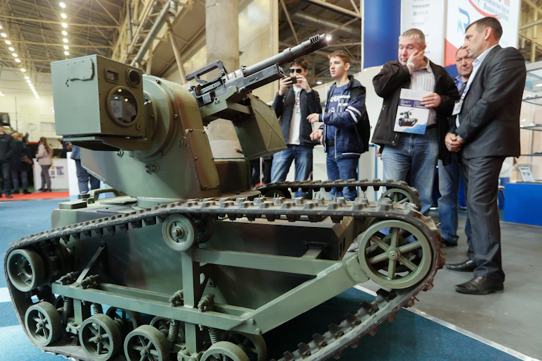 Visitors look at a Ukrainian-made combat robot at an arms fair in Kyiv, Ukraine.