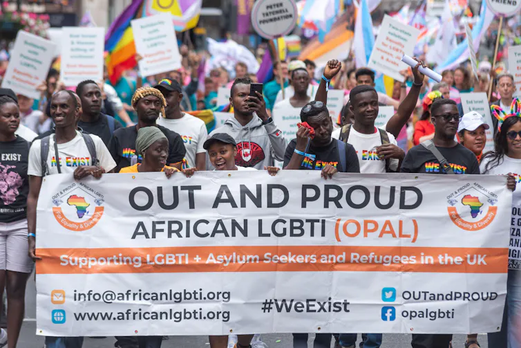 People holding a African LGBTI (Opal) banner at the Pride Parade, London 2025
