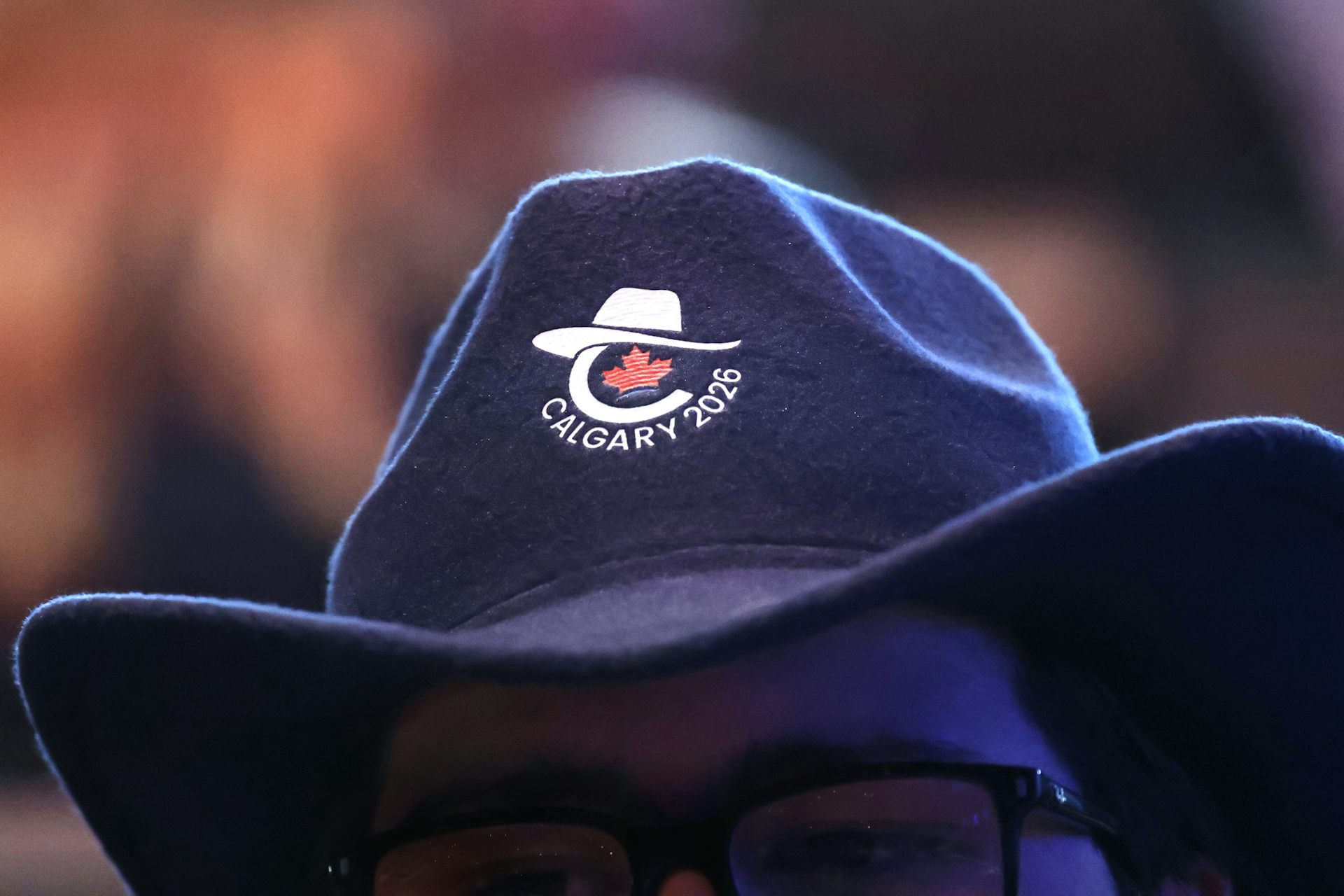 close up of a man wearing a cowboy hat with the Conservative Party logo