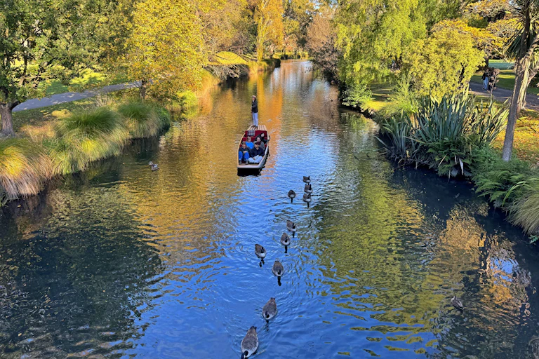 gondola and people on river, birds swimming and green riverbanks