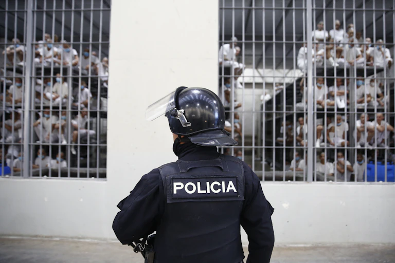 A policeman stands guard outside a cell in the Terrorism Confinement Center prison in El Salvador.