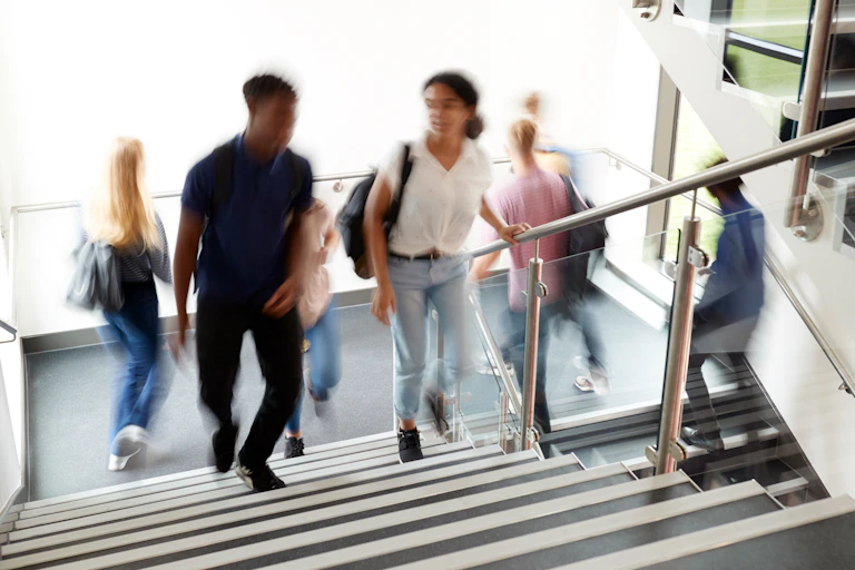 Blurred photo of students in a stairwell at a school