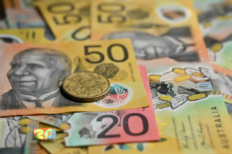 Generic images of Australian fifty and twenty dollar notes and a dollar coin