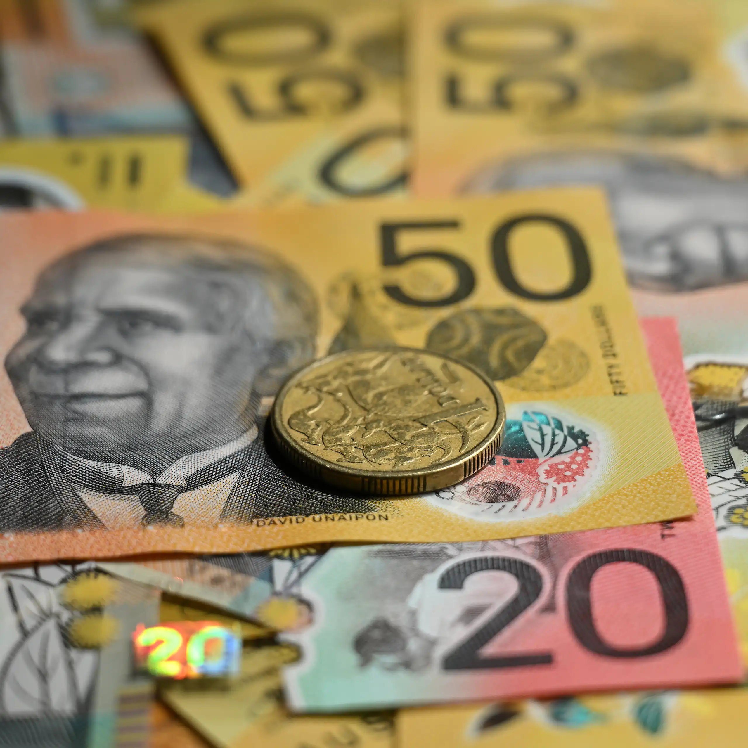 Generic images of Australian fifty and twenty dollar notes and a dollar coin