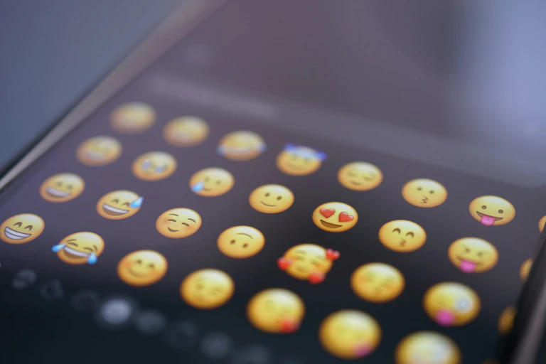 A series of yellow emojis on a smartphone screen.