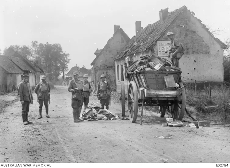soldiers on a street with houses