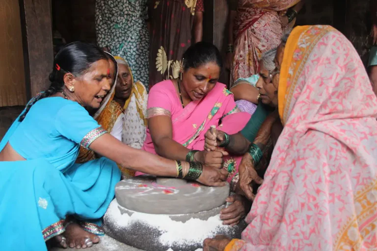 Women singing as they work in rural India.