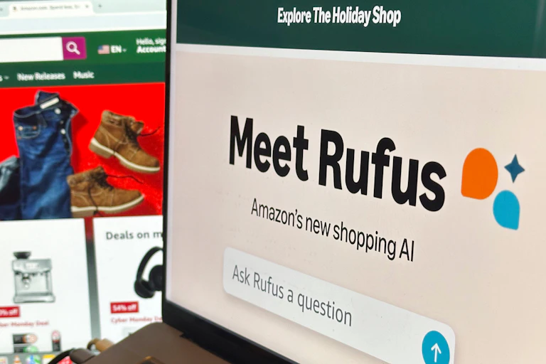 An image of Amazon's AI shopping assistant, Rufus, appears on a computer monitor to greet shoppers at a store in New York City.