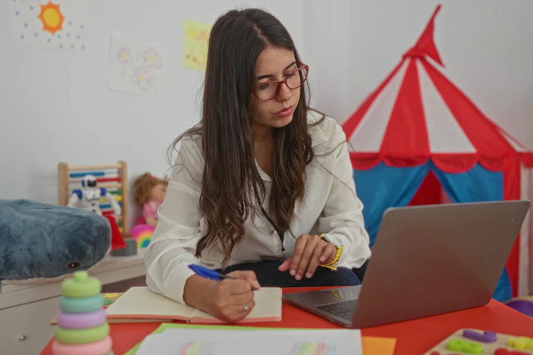 Woman working at laptop in classroom