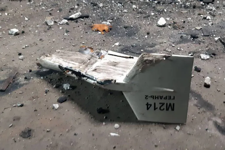 A fragment of a drone rests on the ground.