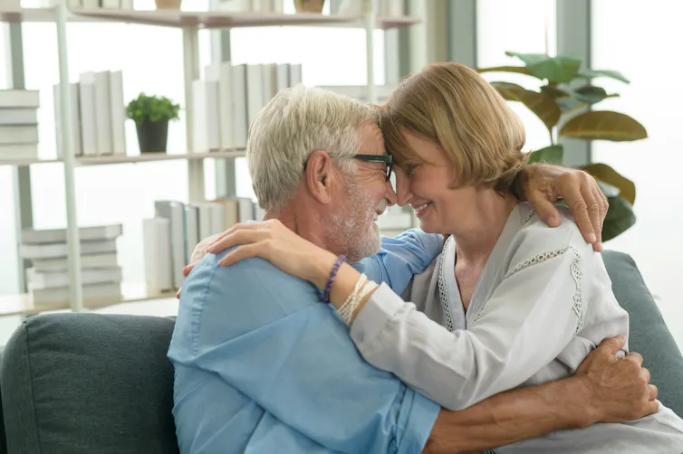 an older white couple embraces