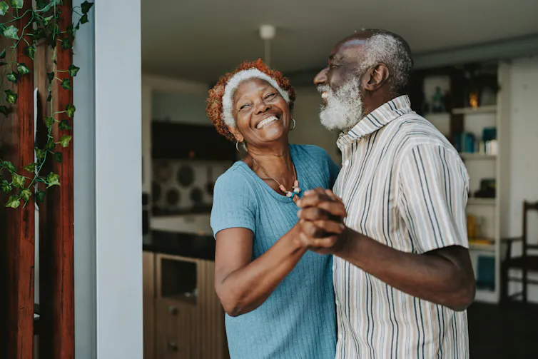 an older black man and woman dance and smile