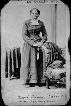 Retrato en blanco y negro de una mujer negra con un vestido del siglo XIX.