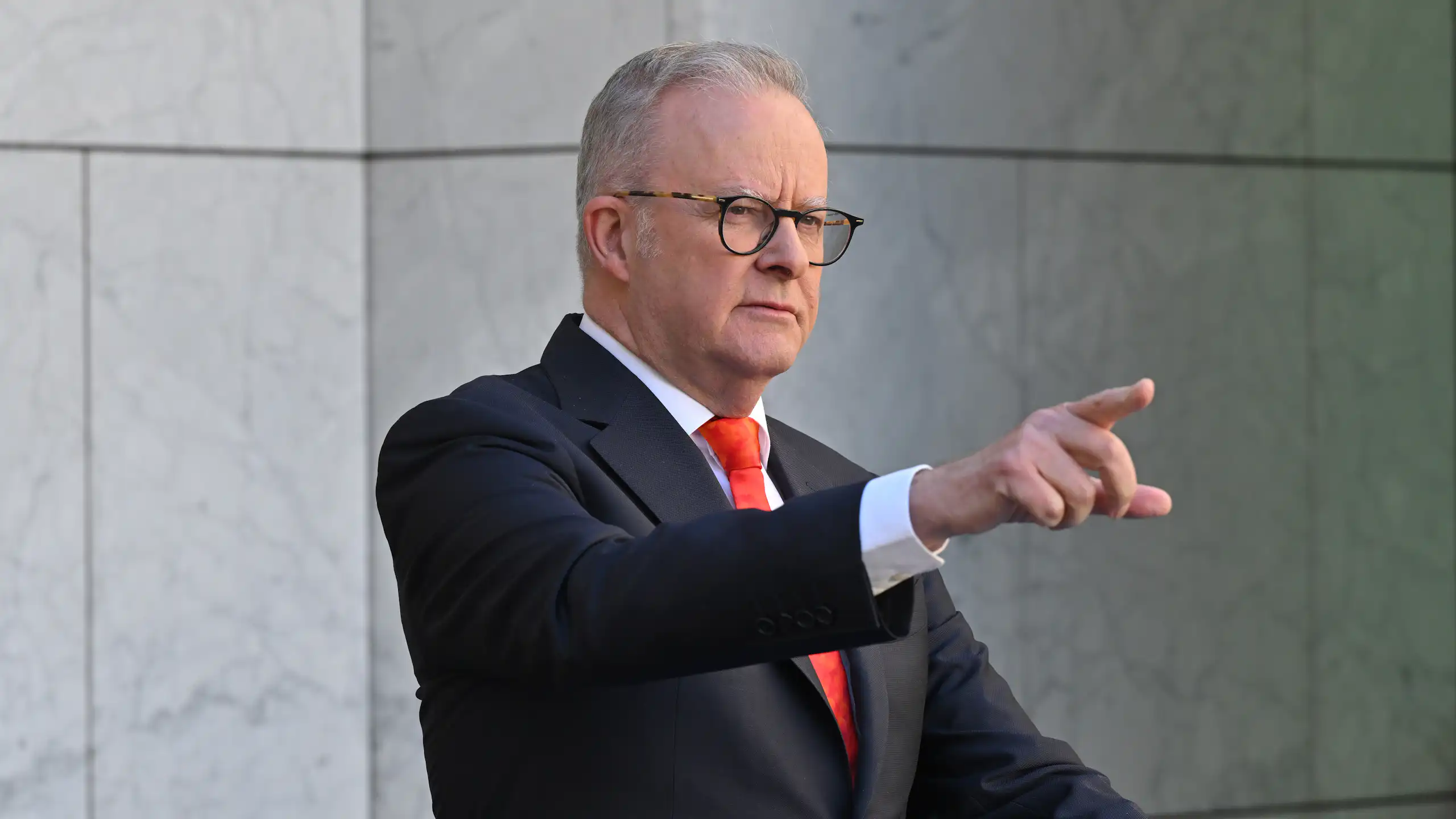 Anthony Albanese points in the air