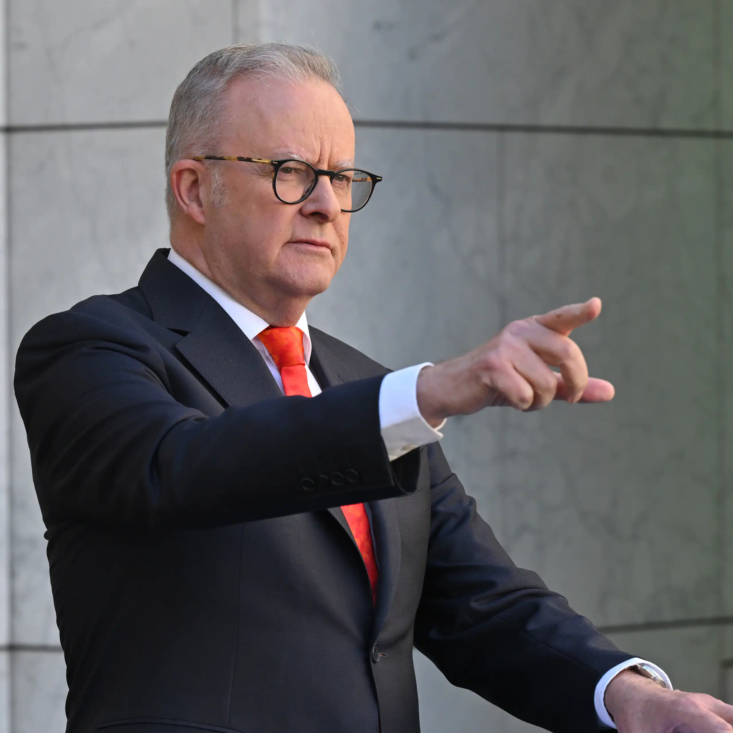 Anthony Albanese points in the air