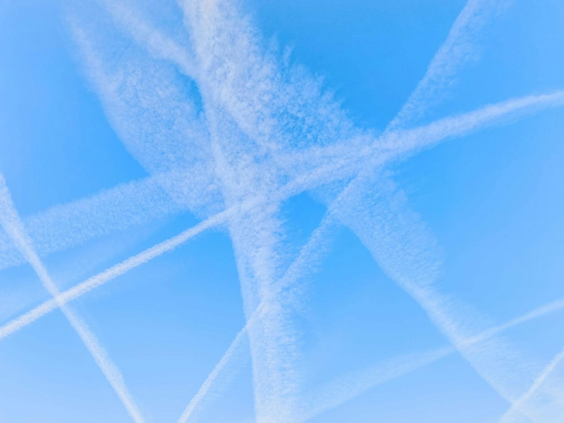 Sky showing numerous trails from aircraft.