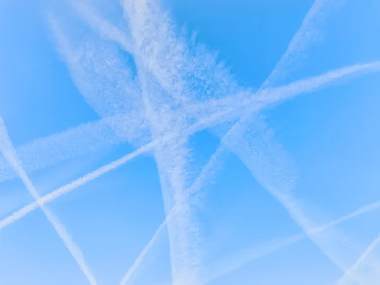 Sky showing numerous trails from aircraft.