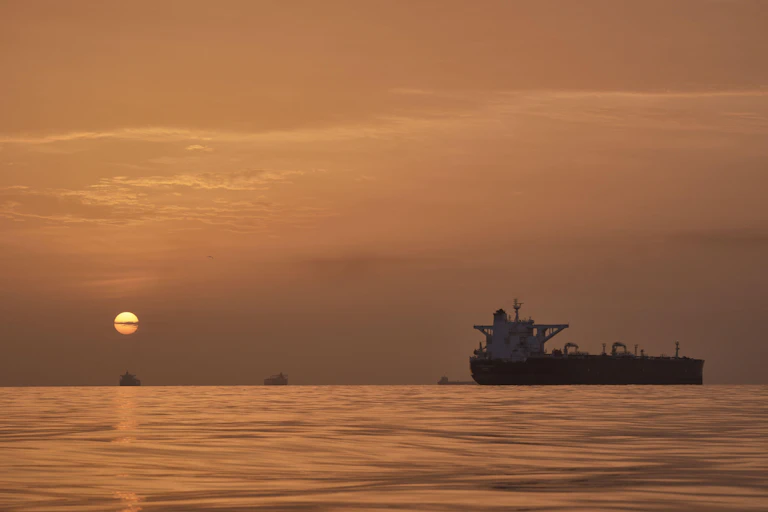 Ships in the Strait of Hormuz as the sun rises.