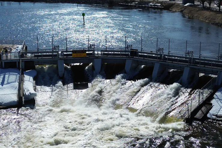 Water spills from the Cheyboygan dam, where the water level came close to the top, threatening the century-old dam's integrity.