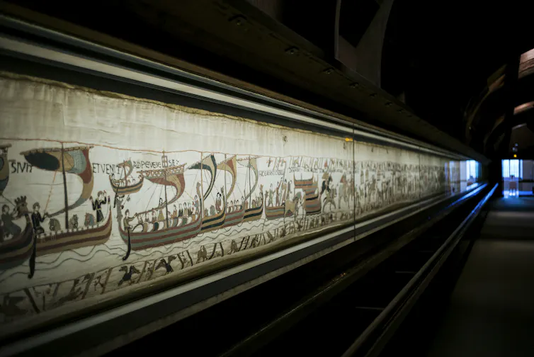 A long tapestry portraying the Norman Conquest.