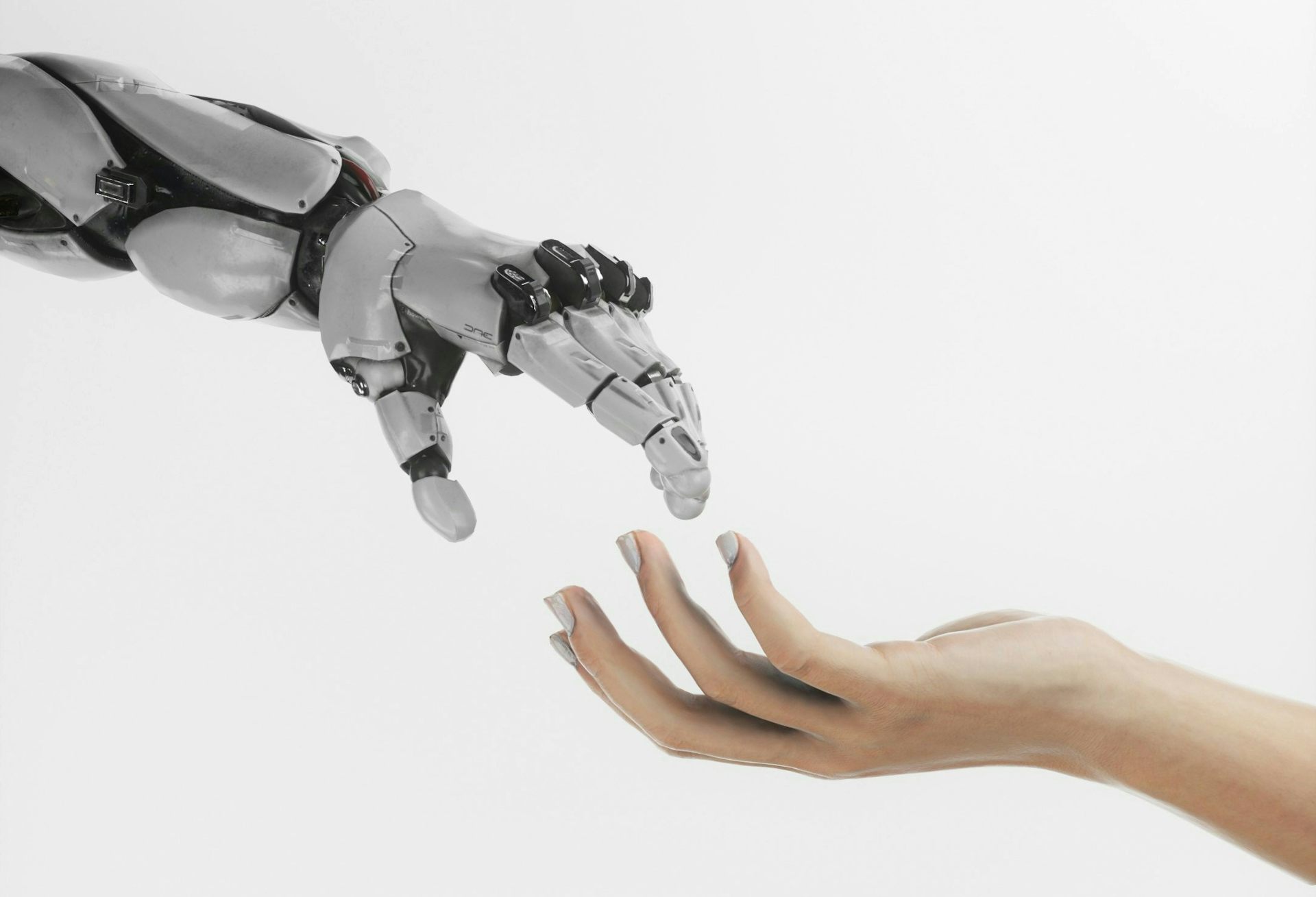 A robotic hand and a human one almost touch.