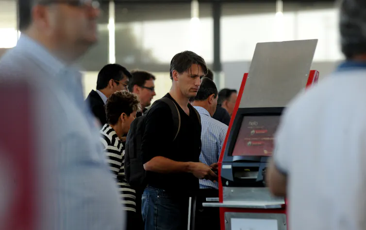 passengers check in at the Virgin airlines counters, the domestic terminal