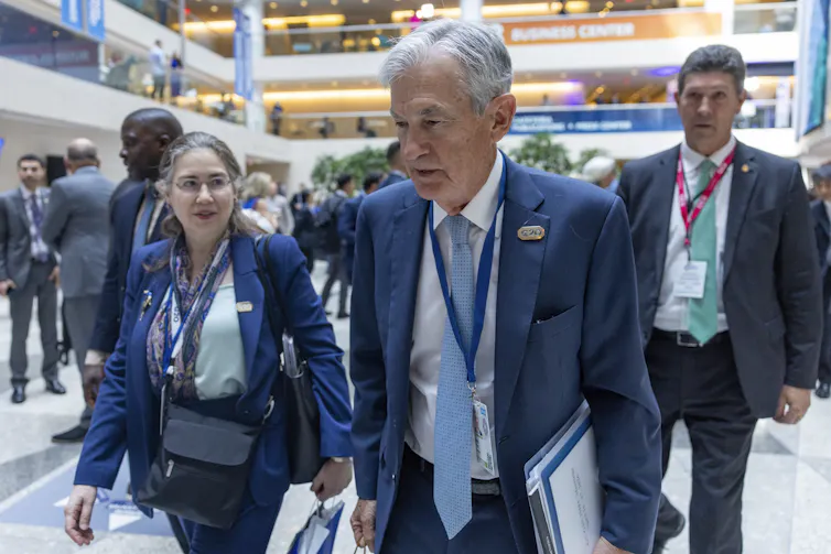 US Federal Reserve Chair Jerome Powell and others seen walking
