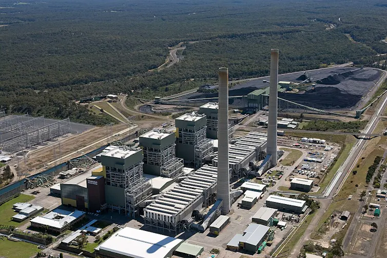 coal power station pictured from the air, large industrial facility and coal stockpile.