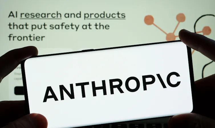 Anthropic AI research company logo on a smartphone with the company's website in the background.